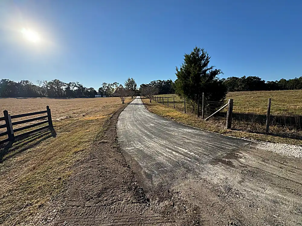 Deteriorated dirt and gravel driveway before paving
