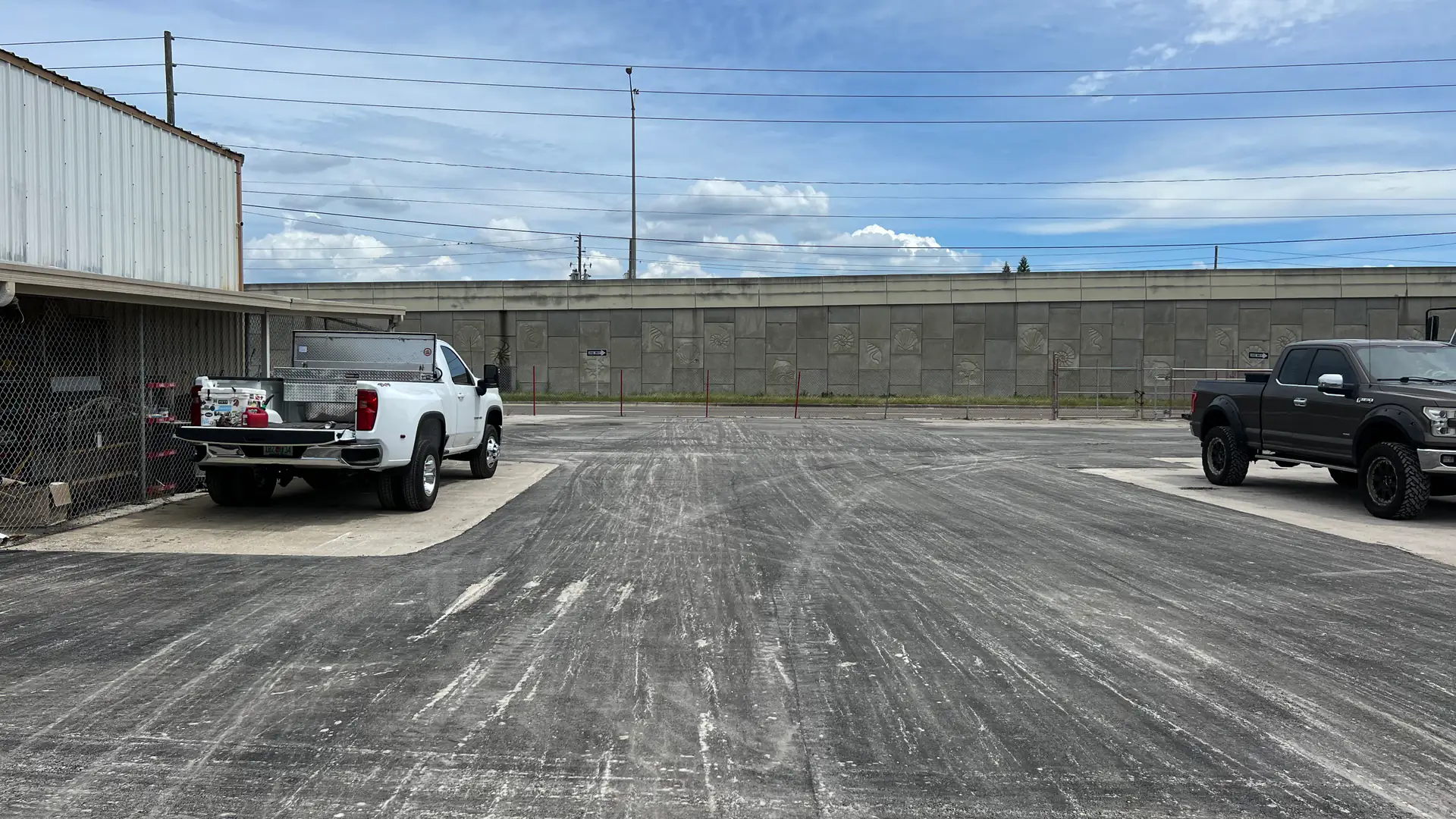 Milled pavement surface across an industrial parking area