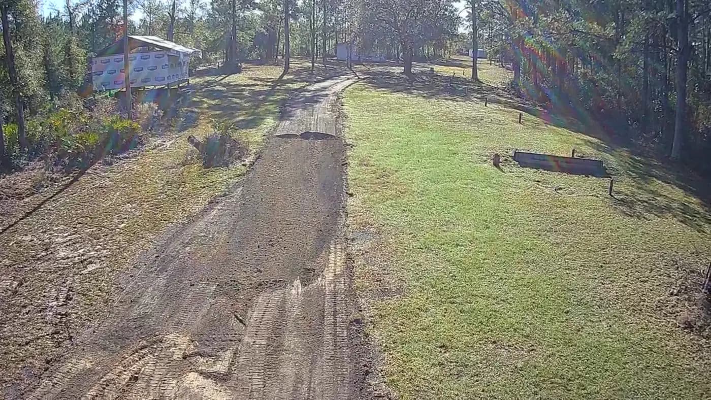 Aerial view of grading and base preparation along a private driveway