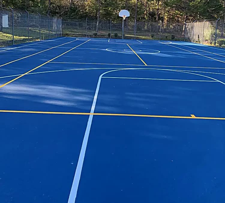 Resurfaced outdoor court with basketball and multi-sport markings