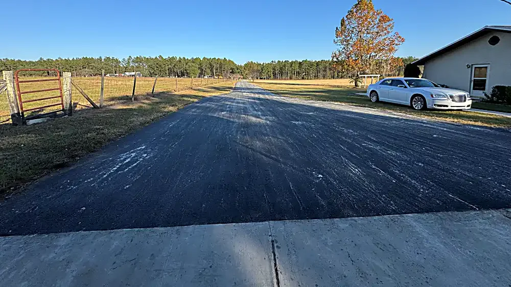 Asphalt millings driveway in Floral City, FL: freshly spread and compacted recycled asphalt millings on a rural residential drive