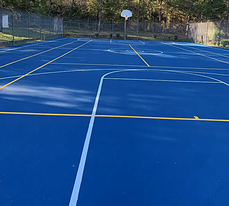 Resurfaced outdoor court with basketball and multi-sport markings